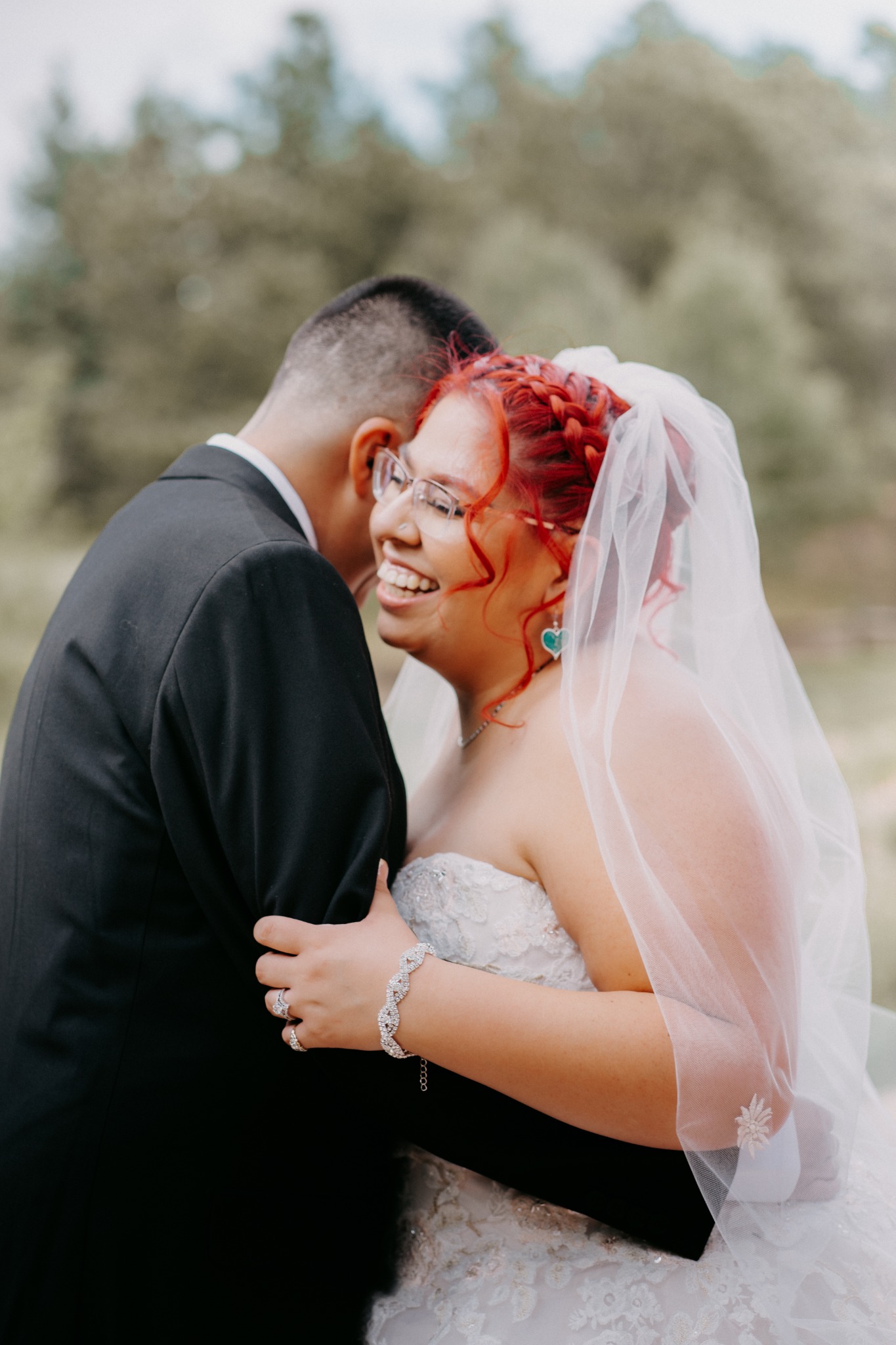 Newlywed couple laughing together outdoors